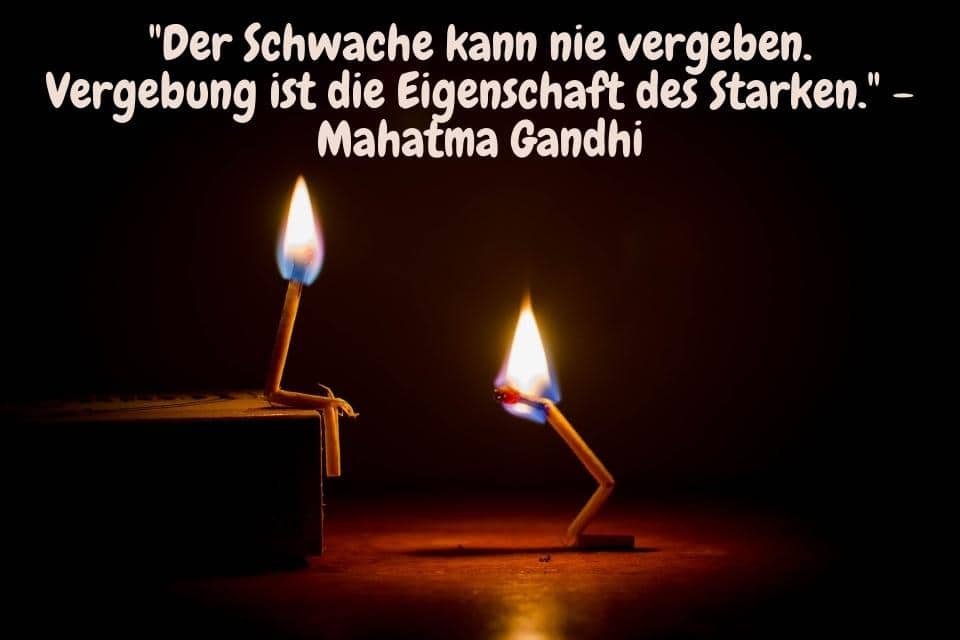 Zwei brennende Streichhhölzer mit Gandhi Zitat - "Der Schwache kann nie vergeben. Vergebung ist die Eigenschaft des Starken." - Mahatma Gandhi